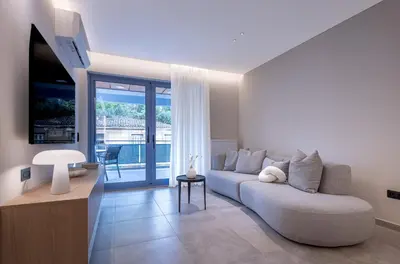a living room with a couch and a television at Phaedrus Living Athens Luxury Residences Golden in Athens