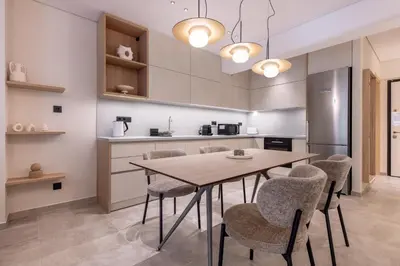 a kitchen with a wooden table and chairs at Phaedrus Living Athens Luxury Residences Golden in Athens