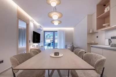a kitchen and dining room with a table and chairs at Phaedrus Living Athens Luxury Residences Golden in Athens