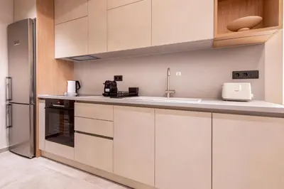 a kitchen with white cabinets and a sink at Phaedrus Living Athens Luxury Residences Ivory in Athens