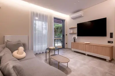 a living room with a couch and a flat screen tv at Phaedrus Living Athens Luxury Residences Ivory in Athens