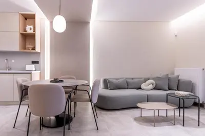 a living room with a couch and a table and chairs at Phaedrus Living Athens Luxury Residences Ivory in Athens