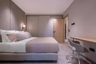 a bedroom with a bed and a desk with a chair at Phaedrus Living Athens Luxury Residences Ivory in Athens