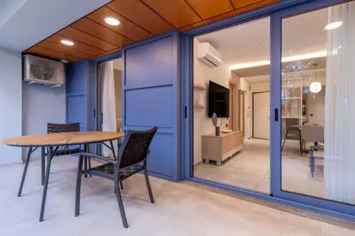 a dining room with blue walls and a table and chairs at Phaedrus Living Athens Luxury Residences Ivory in Athens