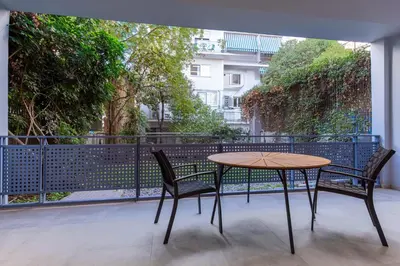 a table and two chairs on a balcony at Phaedrus Living Athens Luxury Residences Ivory in Athens