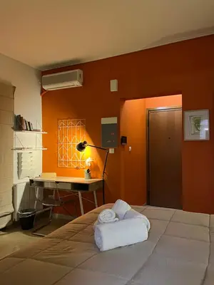 a bedroom with a bed with a desk and a lamp at Tsakalof 10 Veranda by Zeussuites in Athens