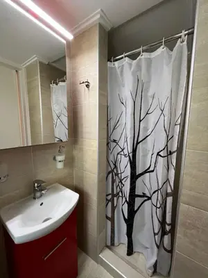 a bathroom with a shower curtain with a tree at Tsakalof 10 Veranda by Zeussuites in Athens