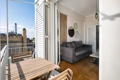 a living room with a couch on a balcony at Helios Apartment by A&A Residences in Athens