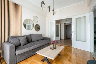 a living room with a couch and a table at Helios Apartment by A&A Residences in Athens