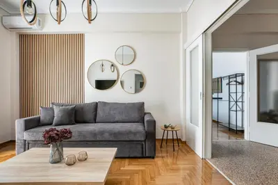 a living room with a couch and a table at Helios Apartment by A&A Residences in Athens