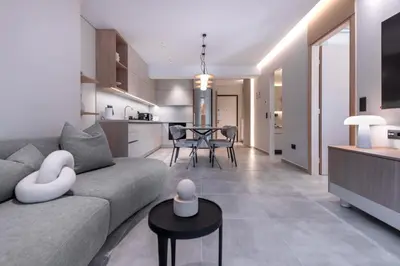 a living room and kitchen with a couch and a table at Phaedrus Living Athens Luxury Residences Sands in Athens
