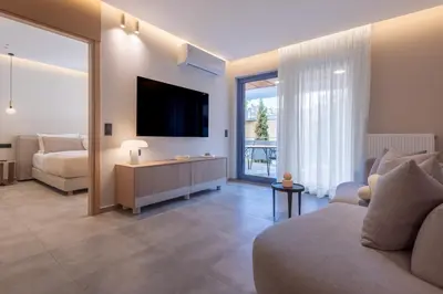 a living room with a couch and a tv at Phaedrus Living Athens Luxury Residences Sands in Athens