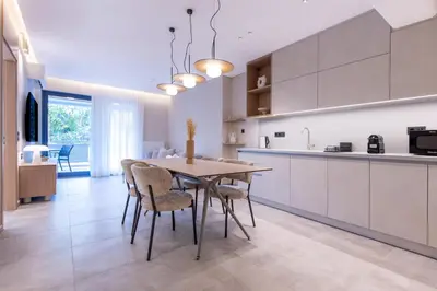 a kitchen and dining room with a table and chairs at Phaedrus Living Athens Luxury Residences Sands in Athens
