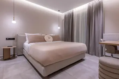 a bedroom with a large bed and a table at Phaedrus Living Athens Luxury Residences Sands in Athens