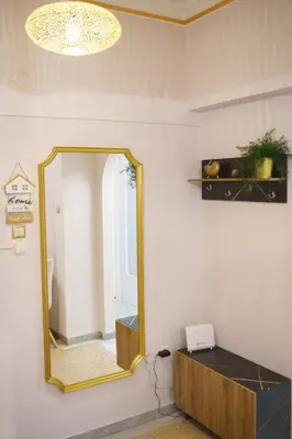 a mirror on a wall in a room at The Golden Embrace in Athens