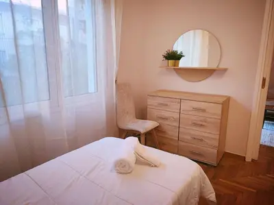 a bedroom with a bed and a dresser and a mirror at The Golden Embrace in Athens