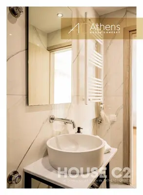 a bathroom with a white sink and a mirror at Athens House Concept Apartments in Athens