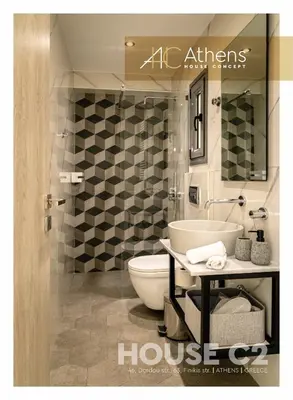 a bathroom with a sink and a toilet in a room at Athens House Concept Apartments in Athens