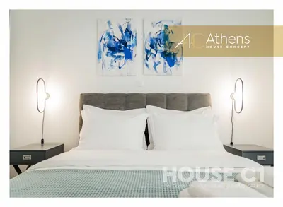 a bedroom with a bed with two lamps and two pillows at Athens House Concept Apartments in Athens