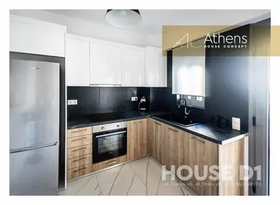 a kitchen with wooden cabinets and a refrigerator at Athens House Concept Apartments in Athens
