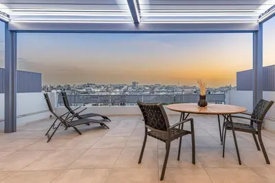 a balcony with a table and chairs and a view at Phaedrus Living Athens Luxury Residences Sunstone in Athens