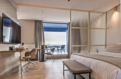 a bedroom with a bed and a table and chairs at Phaedrus Living Athens Luxury Residences Sunstone in Athens