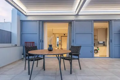 a table and chairs in a room with blue walls at Phaedrus Living Athens Luxury Residences Sunstone in Athens
