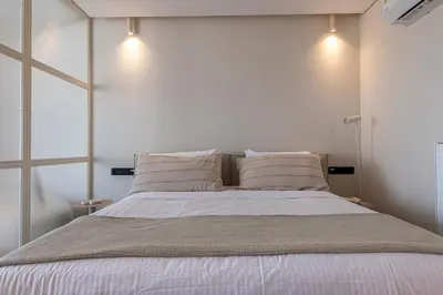 a bedroom with a large bed with white sheets and pillows at Phaedrus Living Athens Luxury Residences Sunstone in Athens