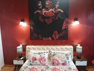 a bedroom with a bed with a painting on the wall at Acropolis Luxe Apartment in Athens