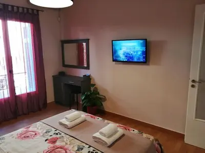a bedroom with a bed with a tv on the wall at Acropolis Luxe Apartment in Athens