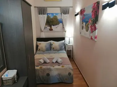 a small bedroom with a bed with towels on it at Acropolis Luxe Apartment in Athens