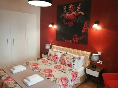 a bedroom with a bed with flowers on it at Acropolis Luxe Apartment in Athens