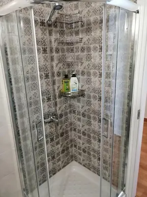 a bathroom with a shower with a glass door at Acropolis Luxe Apartment in Athens