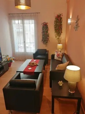 a living room with two couches and a table at Acropolis Luxe Apartment in Athens