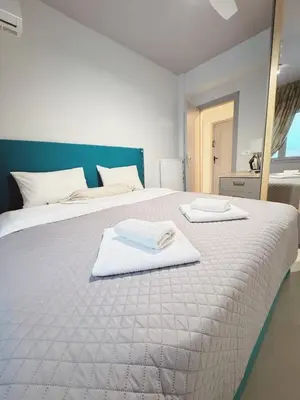 a bedroom with a bed with two towels on it at Minimal 2bd apartment in Thisio in Athens