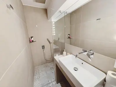 a white bathroom with a sink and a shower at Minimal 2bd apartment in Thisio in Athens