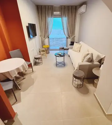 a living room with a couch and a table at Minimal 2bd apartment in Thisio in Athens