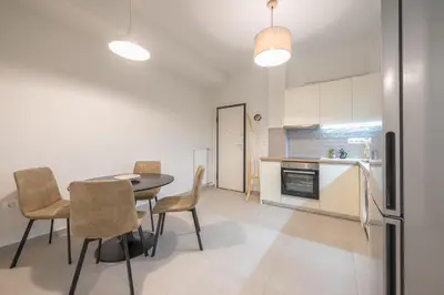 a kitchen and dining room with a table and chairs at Zen Glow, Neapoli in Athens