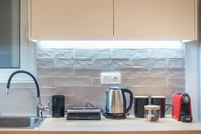 a kitchen counter top with a coffee maker and appliances at Zen Glow, Neapoli in Athens