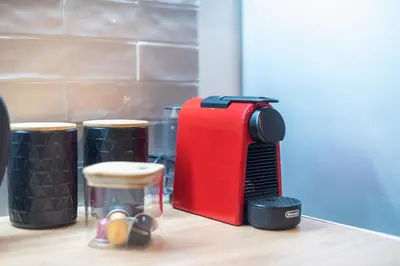 a red toaster sitting on top of a table at Zen Glow, Neapoli in Athens