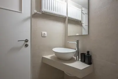a bathroom with a bowl sink on a counter at Zen Glow, Neapoli in Athens