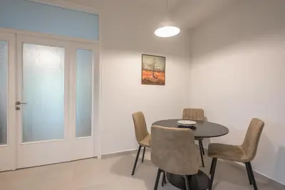 a dining room with a table and chairs at Zen Glow, Neapoli in Athens