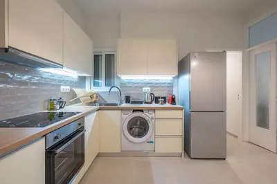 a kitchen with a refrigerator and a washing machine at Zen Glow, Neapoli in Athens