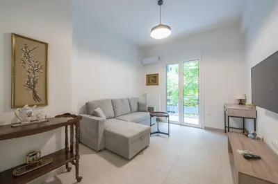 a living room with a couch and a table at Zen Glow, Neapoli in Athens