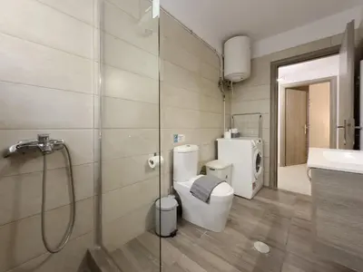 a bathroom with a toilet and a shower and a sink at Terpsixoris cozy apartment in Paleo Faliro in Athens