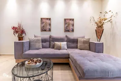 a living room with a purple couch and a glass table at Golden Angel - Elegant Apartment in Egaleo-Athens in Athens