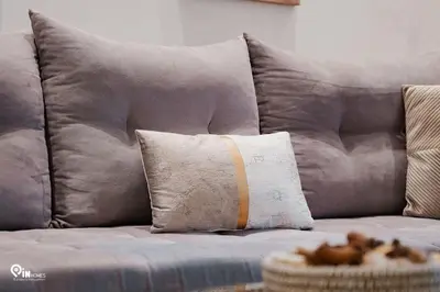 a brown couch with a pillow on it at Golden Angel - Elegant Apartment in Egaleo-Athens in Athens