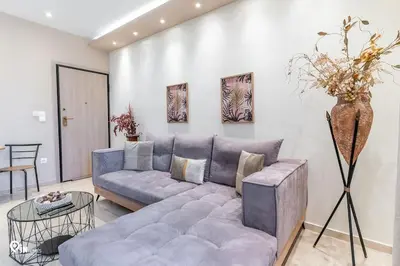 a living room with a couch and a table at Golden Angel - Elegant Apartment in Egaleo-Athens in Athens