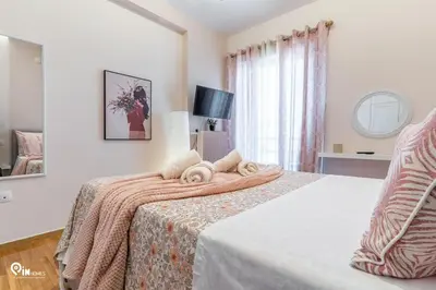 a bedroom with a bed with two towels on it at Golden Angel - Elegant Apartment in Egaleo-Athens in Athens