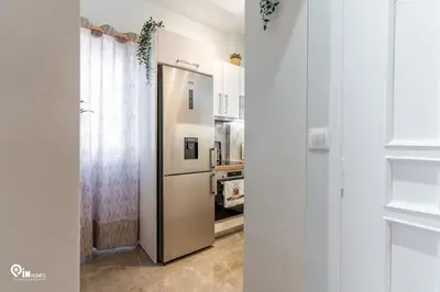a kitchen with a stainless steel refrigerator in a room at Golden Angel - Elegant Apartment in Egaleo-Athens in Athens